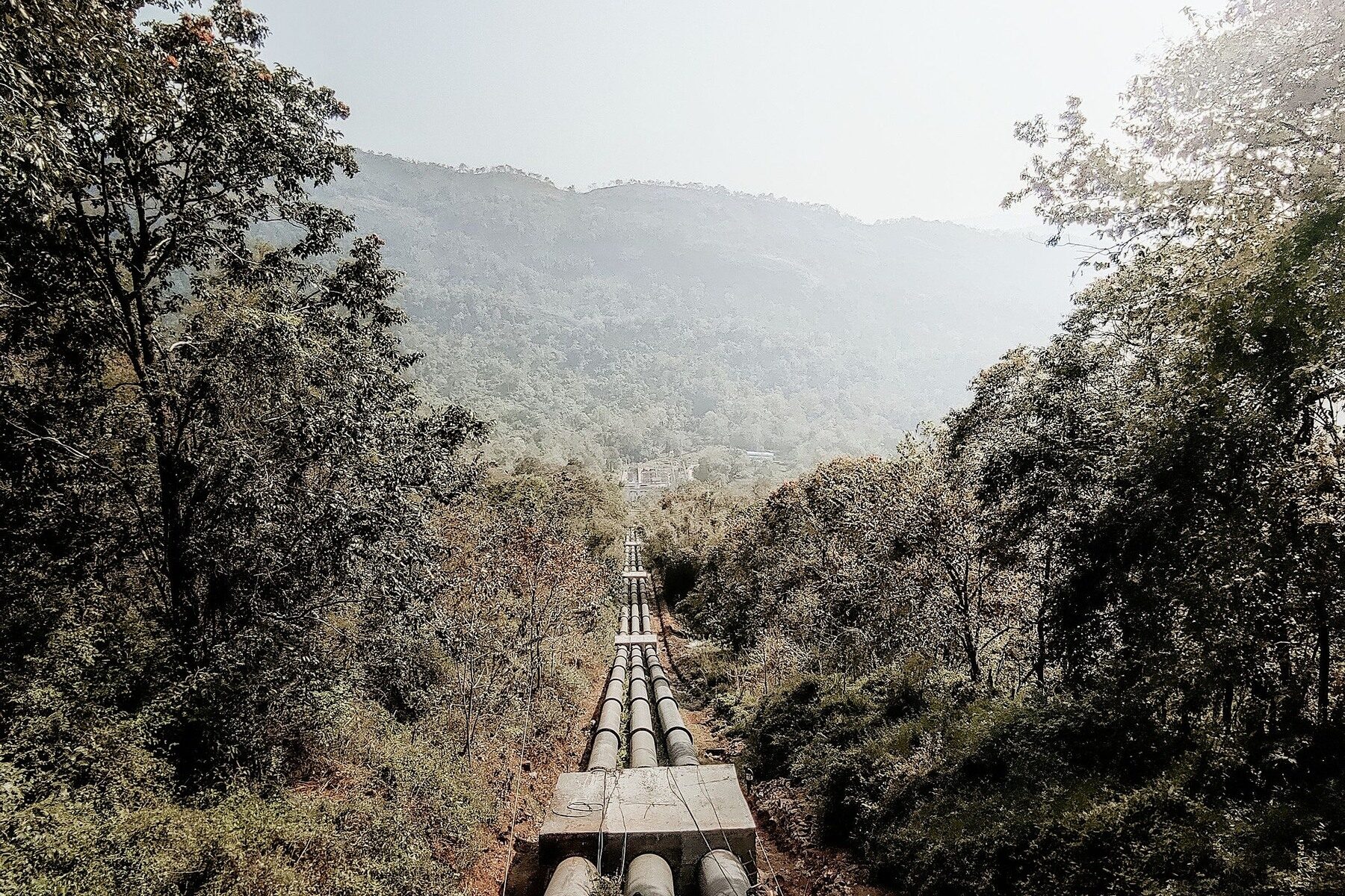 Energy transportation infrastructure crossing a mountain forest corridor